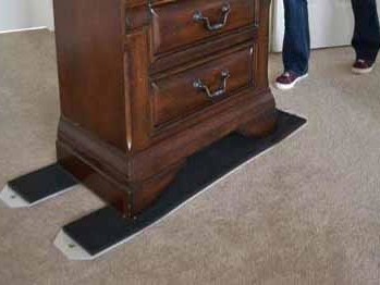 An antique chest of drawers with furniture slider at the base to make it easier to push across a carperted floor